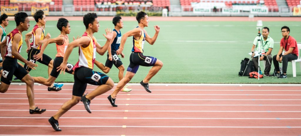 group of men running in track field