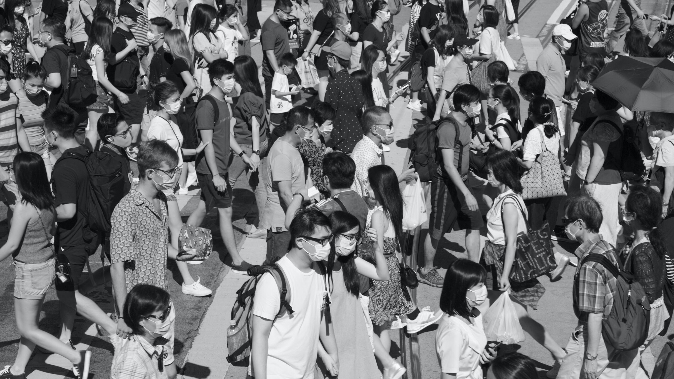 grayscale photo of people gathering on street