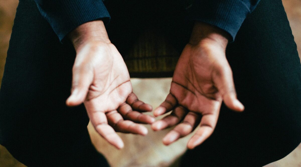 person showing both palms while sitting on chair